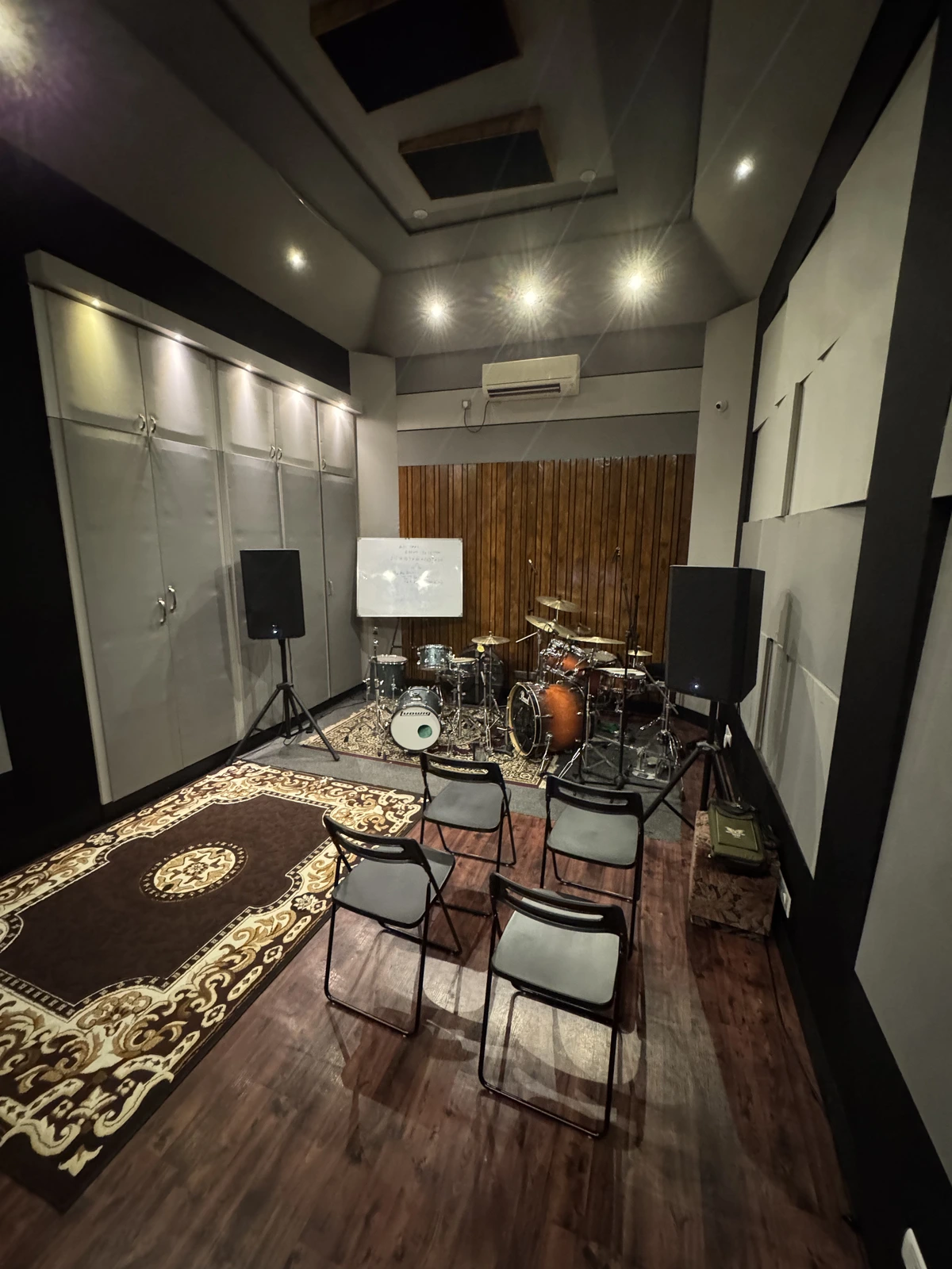 Lesson room set up with chairs, whiteboard, and drum kit ready for a class